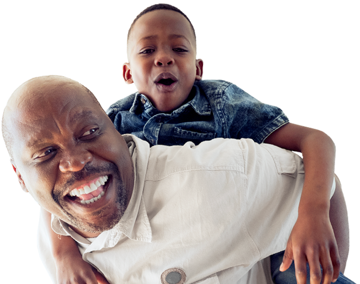 Smiling father giving smiling son a piggyback ride
